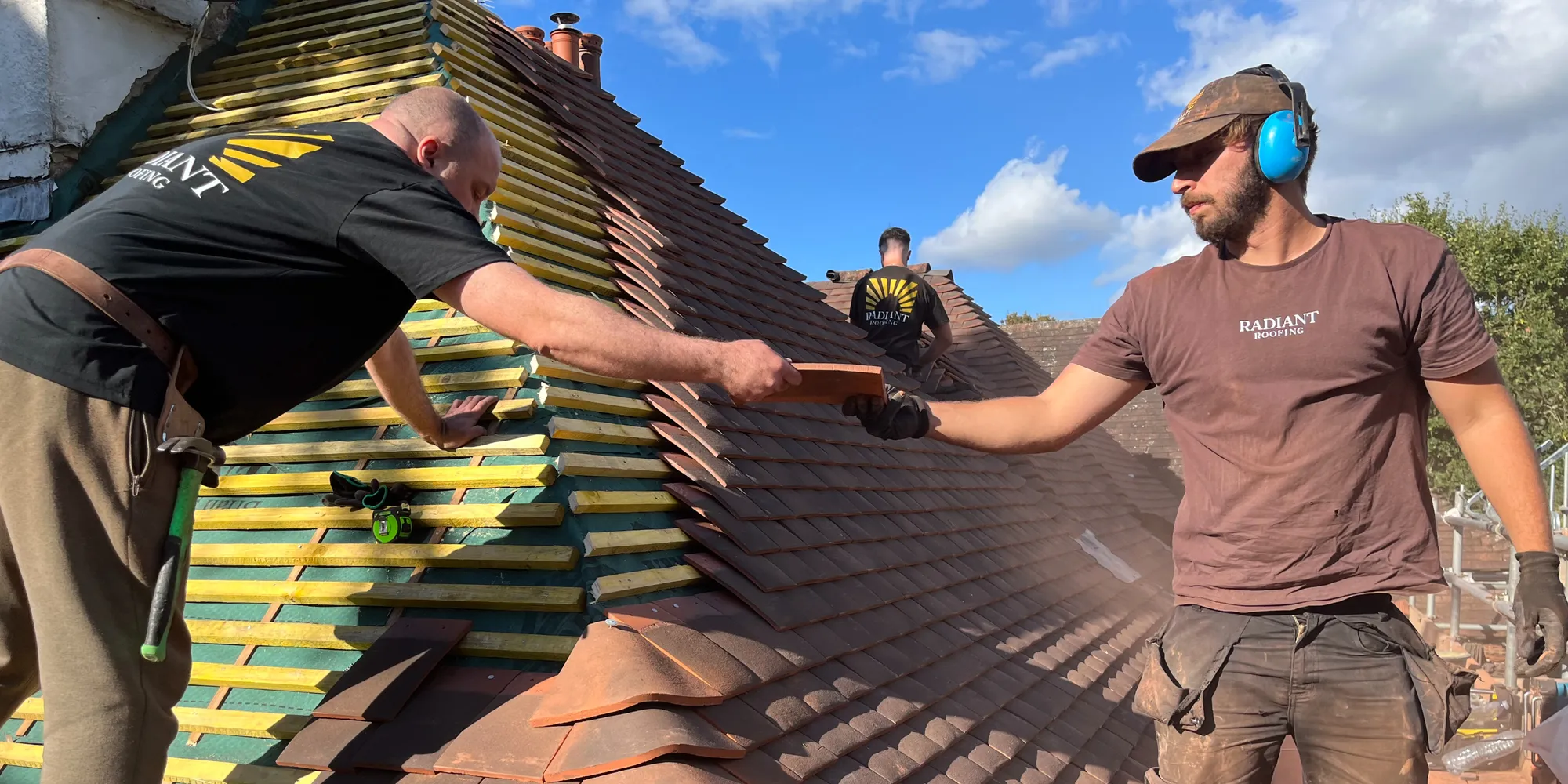 The team at work on a pitched tiled roof