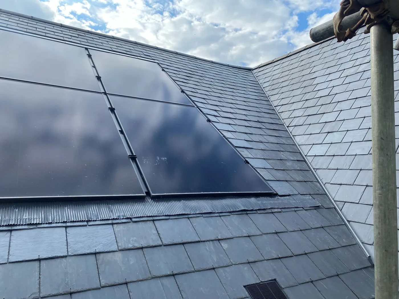 In-roof solar panels sitting flush within a slate roof